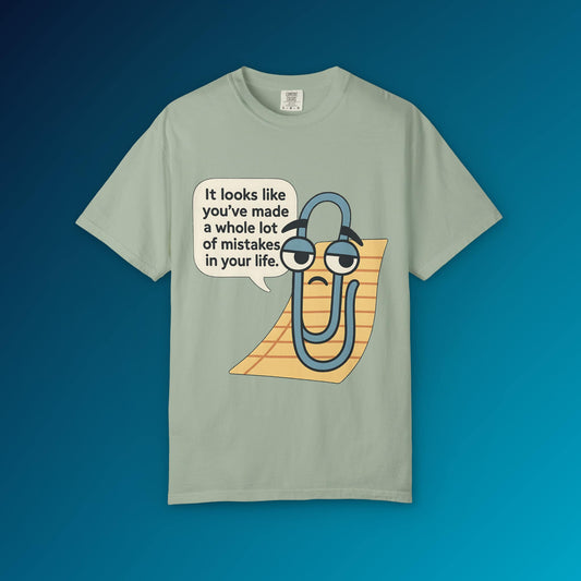 Green t-shirt featuring a cartoon paperclip with a sad face saying you made mistakes