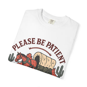 Folded white t-shirt showing the detail of the horse and wagon graphic print.