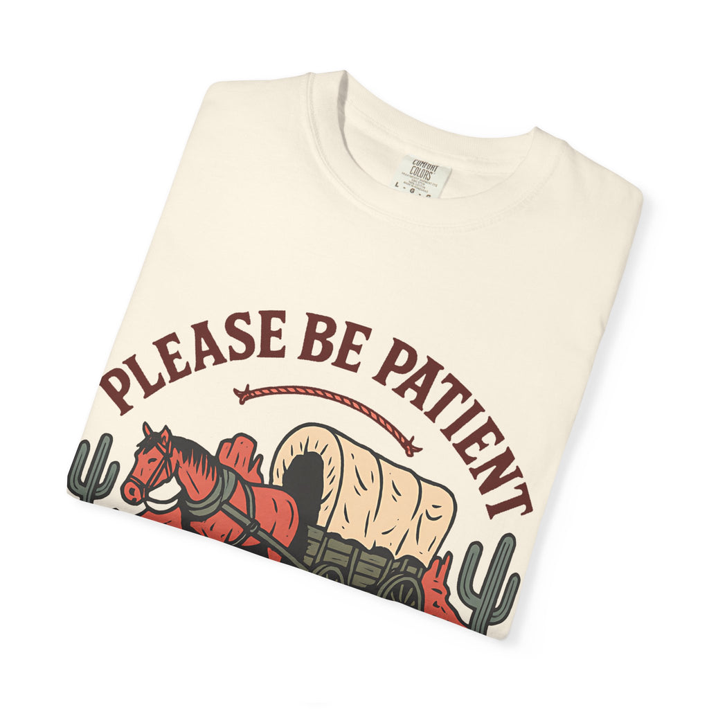 Folded cream t-shirt showing the detail of the horse and wagon graphic print.