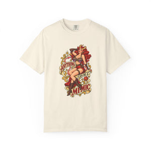 Off-white ivory graphic t-shirt laid flat displaying vintage fantasy campaign artwork of a horned pinup girl and D20 dice.