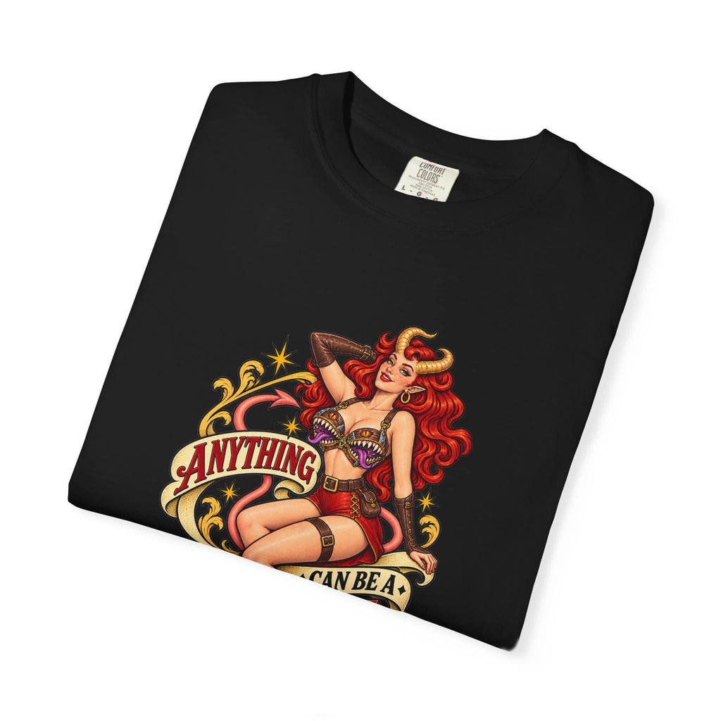 Top-down view of a folded black cotton graphic shirt featuring a retro fantasy pinup girl wearing monster mimic armor.