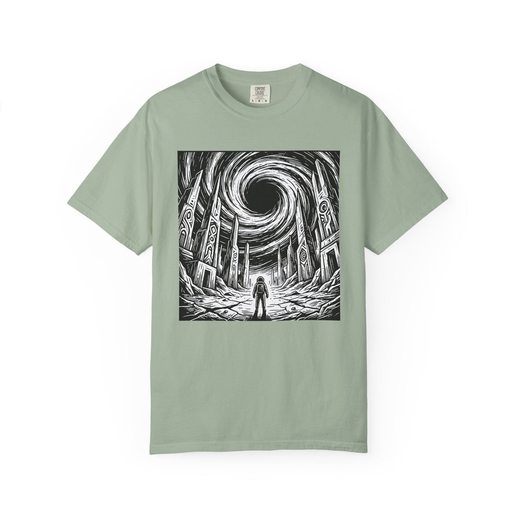 Light sage green t-shirt laid flat displaying the full epic sci-fi graphic of an astronaut standing before crumbling alien ruins under a giant black hole vortex.