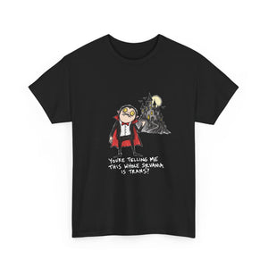 A black short-sleeve crewneck t-shirt featuring a cartoon graphic of a trans boy in a vampire costume next to a castle under a full moon, with the text 'YOURE TELLING ME THIS SHIKE STRAWMA IS TRANS?' printed below.