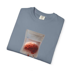 A folded blue-grey t-shirt with a centered graphic of a brain suspended in an IV drip bag