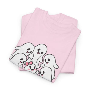 A folded light pink t-shirt featuring a cute cartoon graphic of five smiling ghosts in white with black outlines and pink accents, set against a plain white background.
