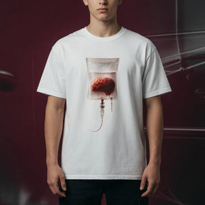 A person wearing a white t-shirt featuring a surreal brain IV drip graphic on the chest
