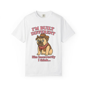 White t-shirt featuring a sad cartoon pug in a cowboy hat with text "I'm Built Different like incorrectly I think".