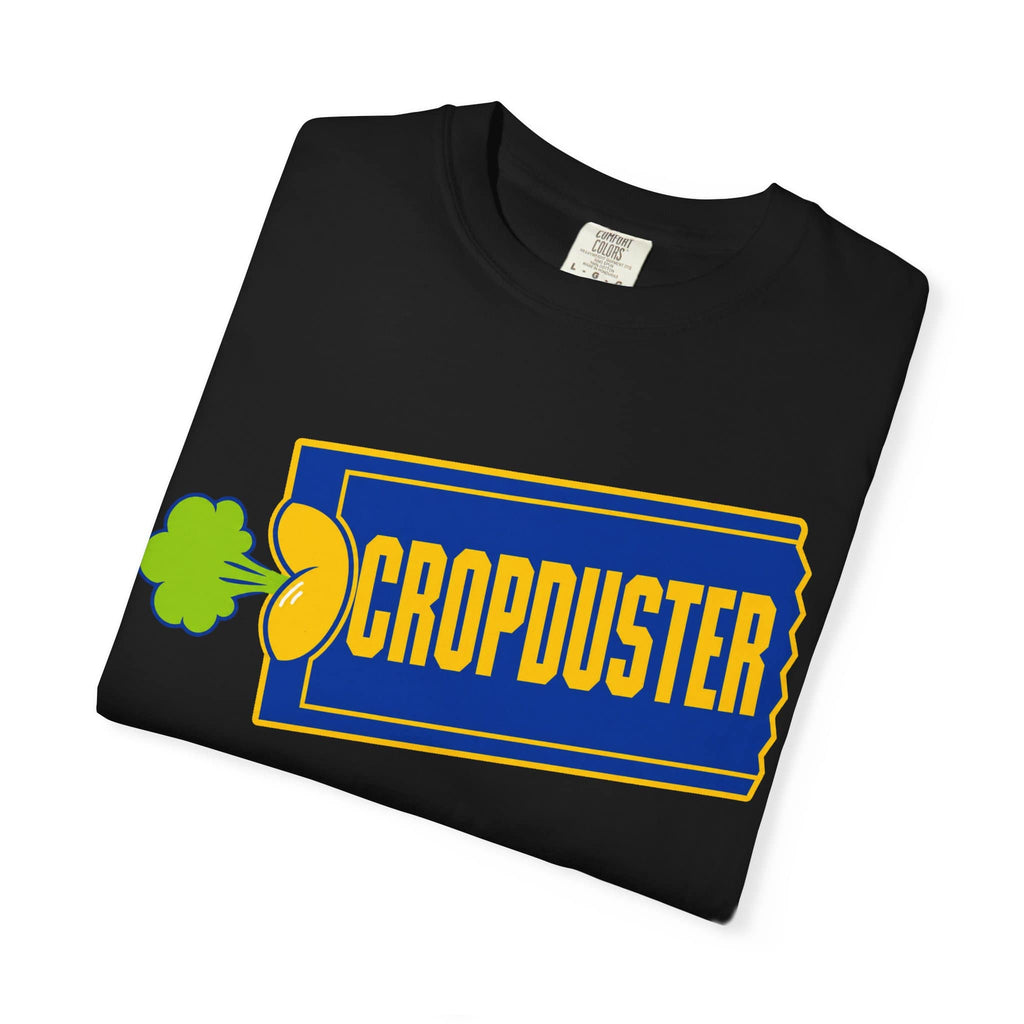 A neatly folded black garment-dyed tee showcasing a funny retro movie rental ticket stub graphic with a neon green cloud emblem.
