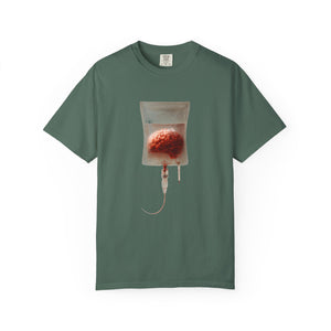 A dark green t-shirt displayed flat, featuring a surreal graphic of a brain suspended in an IV drip bag