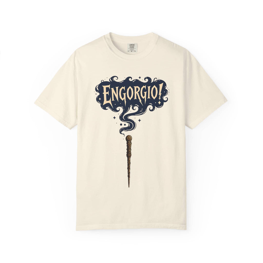 Flat lay of a cream-colored vintage t-shirt featuring a magic wand and swirling Engorgio spell text.