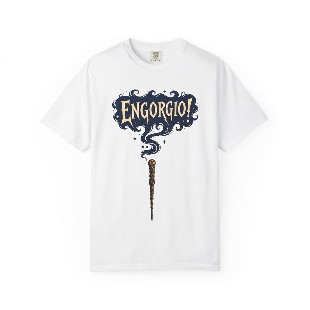 Flat lay of a white t-shirt featuring a magic wand and swirling Engorgio spell text.