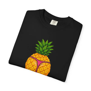 Flat lay of a folded black t-shirt showing a graphic print of a thick pineapple in a pink thong.
