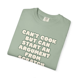 Folded green t-shirt featuring Can’t Cook slogan.
