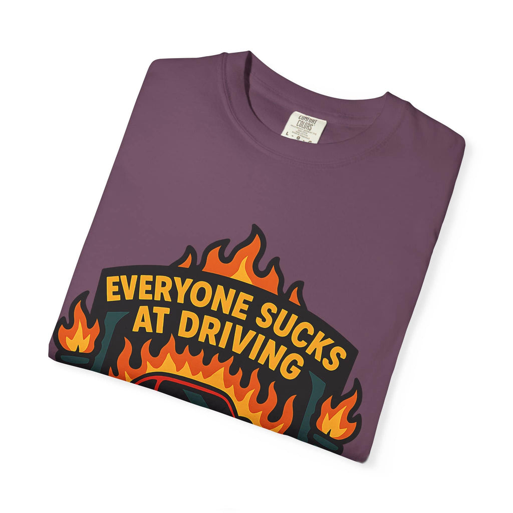 Folded t-shirt with retro badge design with Everyone Sucks At Driving But Me slogan