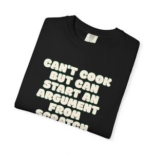 Folded black t-shirt featuring Can’t Cook slogan.