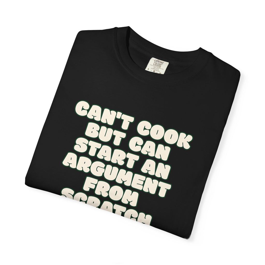 Folded black t-shirt featuring Can’t Cook slogan.