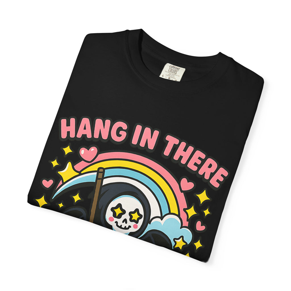 Folded black graphic tee showing high quality DTG print of cute grim reaper and rainbow. Soft ring-spun cotton fabric.