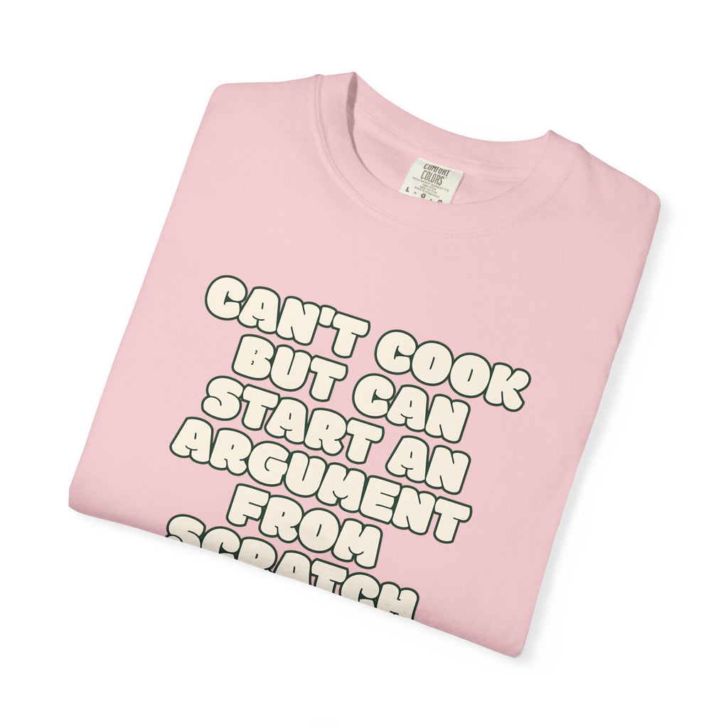 Folded pink t-shirt featuring Can’t Cook slogan.