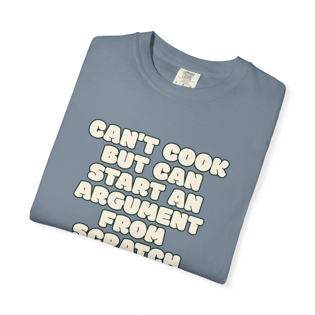 Folded blue t-shirt featuring Can’t Cook slogan.