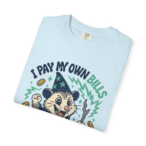 Folded light blue cotton funny meme tee with 'I Pay My Own Bills I Can Cuss All I Want' graphic