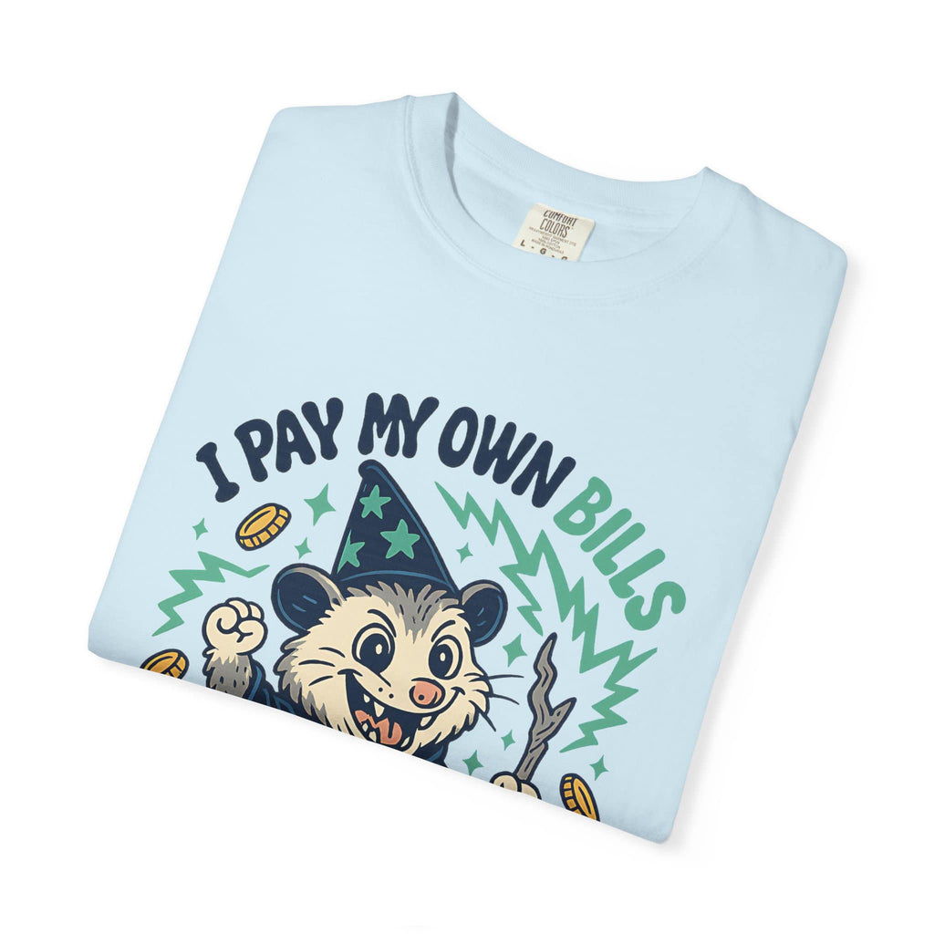 Folded light blue cotton funny meme tee with 'I Pay My Own Bills I Can Cuss All I Want' graphic