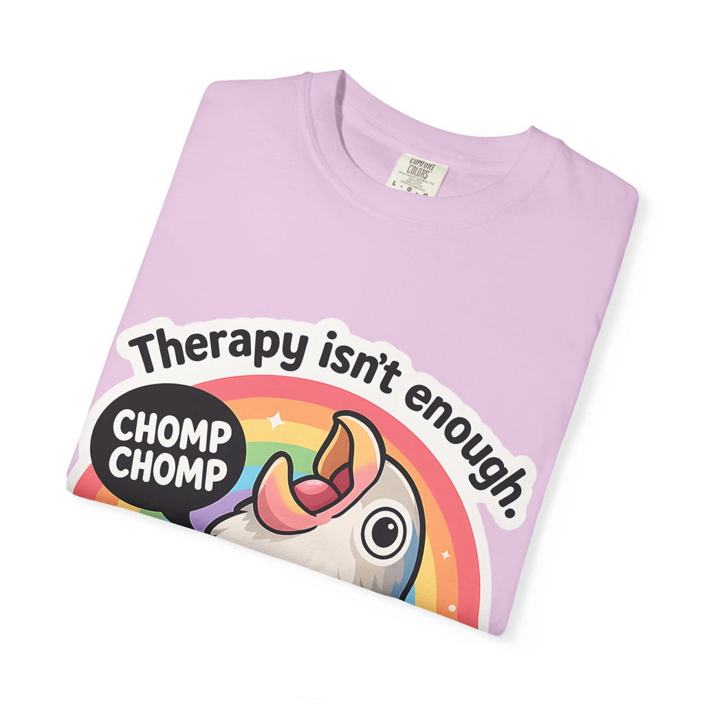 Neatly folded pink t-shirt showing the "Therapy isn't enough" graphic design.
