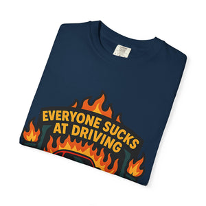 Folded t-shirt with retro badge design with Everyone Sucks At Driving But Me slogan