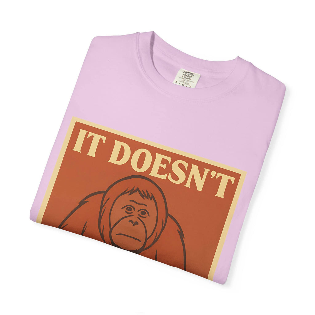 Folded light pink t-shirt featuring a retro poster of a sad orangutan with text 'It Doesn't Get Better