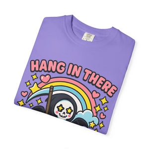 Folded violet purple t-shirt showing detailed cute grim reaper print. Trendy Gen Z humor clothing.