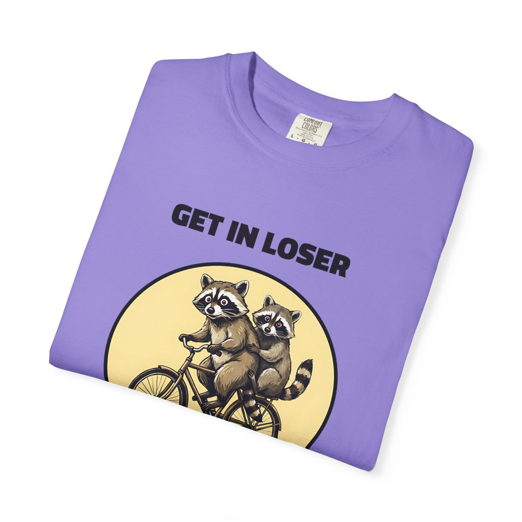 Folded violet t-shirt featuring Get In Loser We’re Getting Trashed meme design.