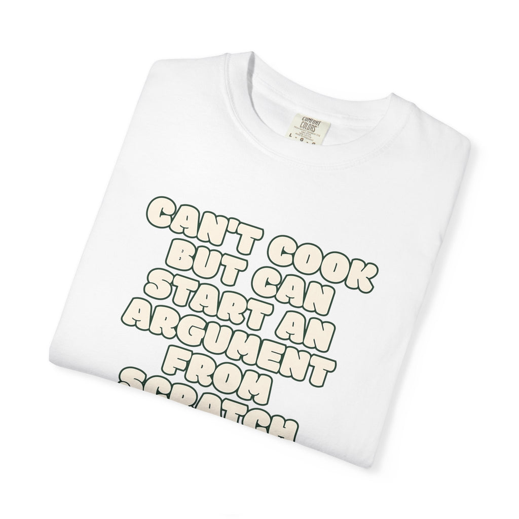 Folded white t-shirt featuring Can’t Cook slogan.