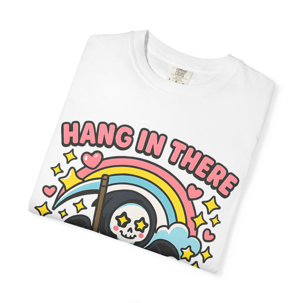 Folded white graphic tee showing high quality DTG print of cute grim reaper and rainbow. Soft ring-spun cotton fabric.