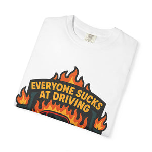 Folded t-shirt with retro badge design with Everyone Sucks At Driving But Me slogan