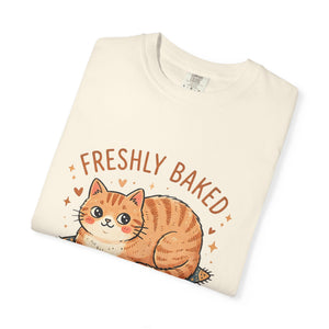 Neatly folded ivory Comfort Colors 1717 t-shirt showing the cute orange cat loaf graphic facing upward.