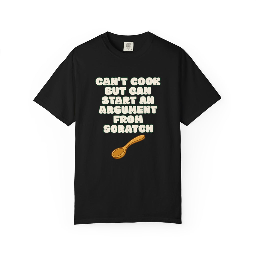 Flat lay of black graphic t-shirt on white background featuring Can’t Cook slogan.