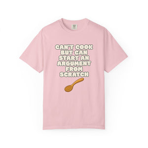 Flat lay of pink graphic t-shirt on white background featuring Can’t Cook slogan.