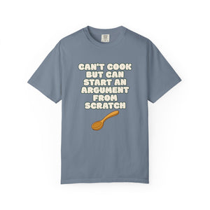 Flat lay of blue t-shirt on white background featuring Can’t Cook slogan.