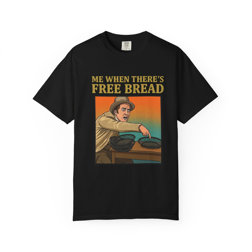 Flat lay of black graphic t-shirt on white background featuring Me When There’s Free Bread design.
