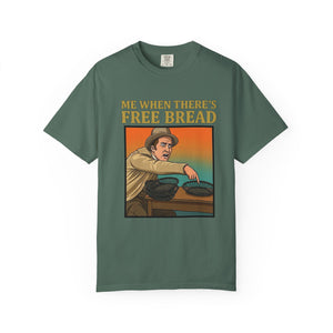 Flat lay of blue spruce graphic t-shirt on white background featuring Me When There’s Free Bread design.