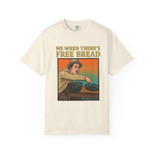 Flat lay of ivory graphic t-shirt on white background featuring Me When There’s Free Bread design.