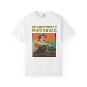 Flat lay of white graphic t-shirt on white background featuring Me When There’s Free Bread design.