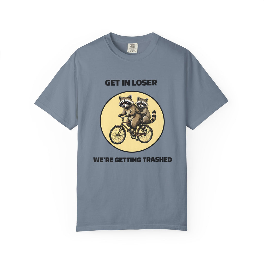 Flat lay of blue jean graphic t-shirt on white background featuring Get In Loser We’re Getting Trashed meme design.