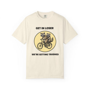 Flat lay of ivory graphic t-shirt on white background featuring Get In Loser We’re Getting Trashed meme design.