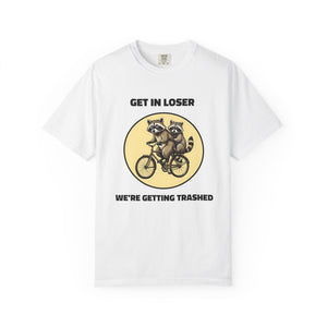 Flat lay of white graphic t-shirt on white background featuring Get In Loser We’re Getting Trashed meme design.