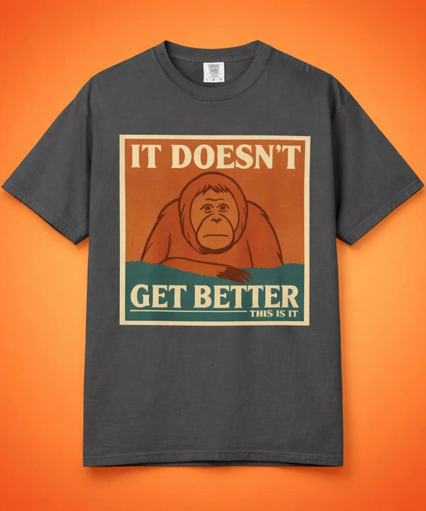 Dark grey t-shirt featuring a retro poster of a sad orangutan with text 'It Doesn't Get Better