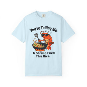 Flat lay of light blue graphic t-shirt on white background featuring shrimp fried rice design. 
