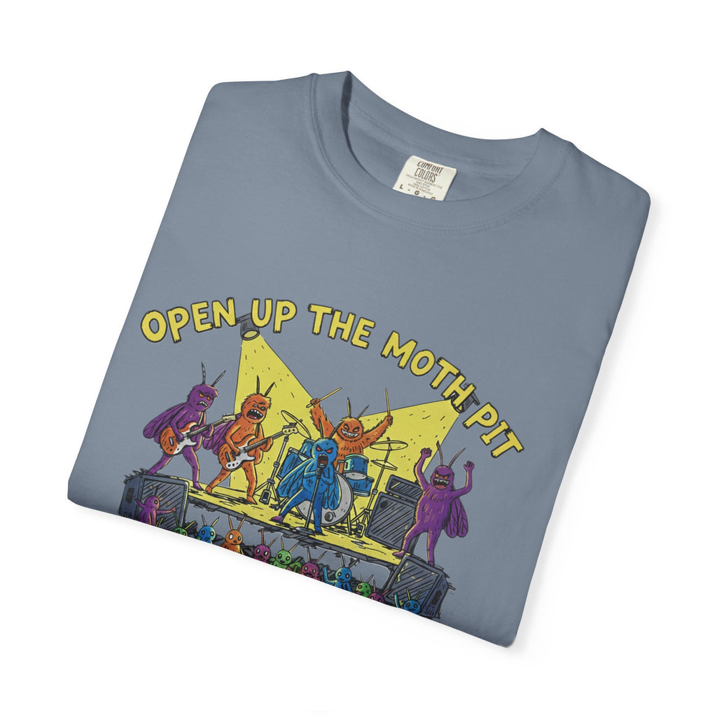 A blue-grey Comfort Colors t-shirt folded to highlight the "Open Up The Moth Pit" design, featuring detailed insect musicians and a crowd of smaller moths in a mosh pit.