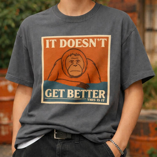 Dark grey t-shirt featuring a retro poster of a sad orangutan with text 'It Doesn't Get Better