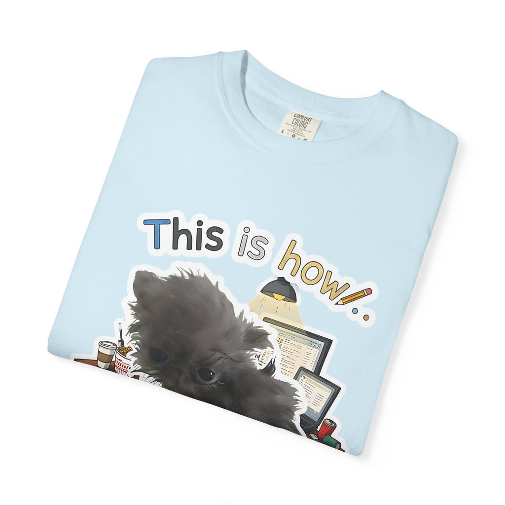 Folded light blue t-shirt showing the "This is how your email finds me" graphic with a stressed dog.
