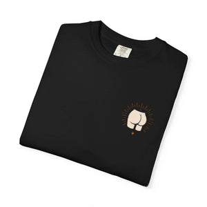 Neatly folded black t-shirt showing the front left-chest pocket graphic of a minimalist butt with radiating lines.